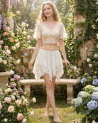 White sheer tiered mini skirt with lace overlay and asymmetric layered hem
