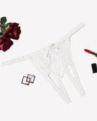 White lace thong panties with floral pattern and scalloped edges, low-rise style.
