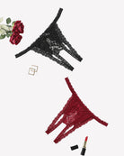 Set of lace thong panties in black and red with floral pattern, low-rise cut.