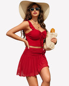 Red mesh mini skirt with rosette waistband, pleated tiers, and short layered hem.