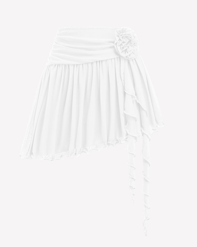 White mesh mini skirt with ruched waistband, layered ruffle hem and large flower accent