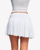 White mesh mini skirt with ruched waist and flowy asymmetric hem, layered ruffles