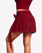 Wine red mesh mini skirt with ruched waistband and cascading side ruffle ties