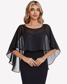 Black chiffon cape shawl with loose flutter sleeves over a black fitted dress