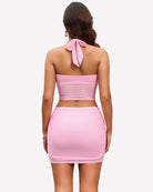 Two-piece skirt set with pink halter crop top and bodycon mini skirt, back view