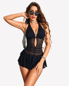 Black halter mini dress with sheer center panel, deep V cutout, ruffle hem and built-in shorts