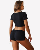 Black low-rise lounge shorts with ruched waistband and side slit