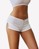 White low-rise lounge shorts with ruched waistband and side slit detail