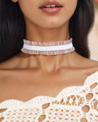 White lace choker with layered ruffled edge, close-up on neck