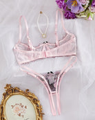 Embroidered underwire bra and thong panty set in lilac-pink lace with bow accents