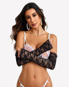 Long black lace fingerless gloves with frilled cuffs on model, sheer forearm coverage