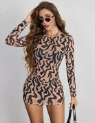 Brown and black abstract leopard mini dress with long sleeves and crew neck