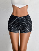 High-rise ruched mini shorts, black with white polka dots and elastic waistband