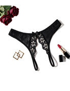 Black low-rise lace mesh thong with floral cutout lace and bow