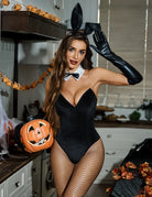 Black velvet bunny bodysuit with white collar, fishnet stockings, and tall ear headband