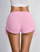 Back view of pink mini shorts with side drawstrings