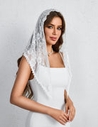 White lace mantilla chapel veil with floral embroidery and scalloped trim drape.