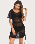 Black lace swimwear cover-up with short sleeves, zigzag pattern, and side fringe ties