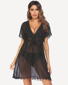 Black sheer swimsuit cover up with deep V-neck, tie waist, pom-pom tassel hem