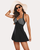 Black polka-dot halter tankini swimsuit with bow tie and flared skirt