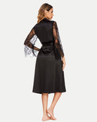 Black satin kimono robe with floral lace sleeves and waist tie belt, back view