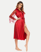 Red satin kimono robe with lace sleeves and tied waist belt, front side view