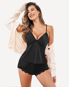 Black pajama set with lace-trim cami top and scalloped hem matching shorts