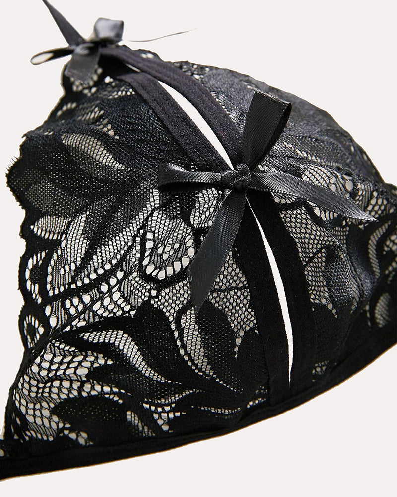 Black lace bra fabric detail with ribbon bow and floral mesh pattern