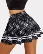 Pleated school uniform skirt, black with white plaid pattern and striped hem band.