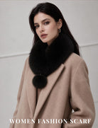 Black faux fur collar scarf with a single pom-pom, worn over a coat.