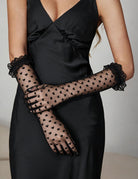 Black sheer heart-print gloves, shown with lace-trimmed ruffle wrists