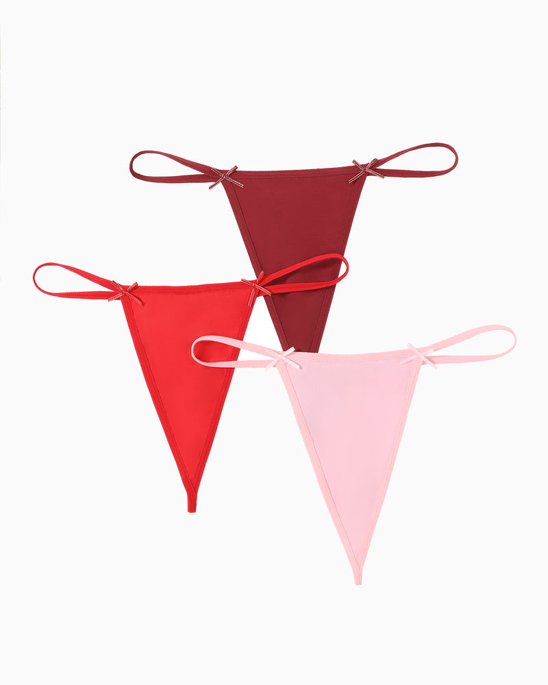 Three G-string thongs: dark red, red, and pink