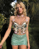 Embroidered butterfly crop top with pink sequin mini skirt and pearl chain, butterfly appliques