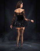 Black off-shoulder lace corset costume with flared tulle skirt and fishnet stockings, back