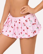 Pleated ruffle mini skirt in pink with red cherry print and layered pleats