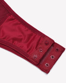 Wine red lace bodysuit sleeve cuff close-up with small button detailing