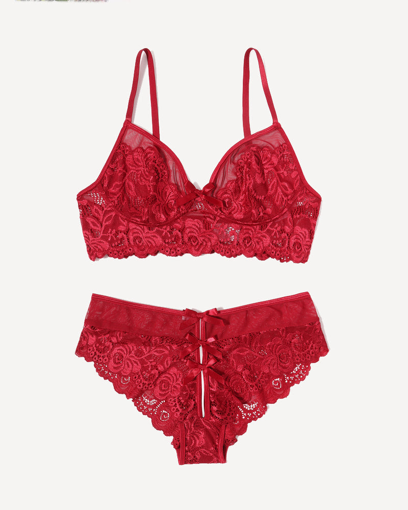 Red lace bra and panty set laid flat, scalloped edges and bow detail