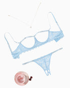 Cupless lace bra and panty set, light blue, flat lay with matching straps