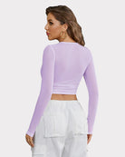 Sheer mesh long sleeve crop top in lilac, back view with ruched waistband