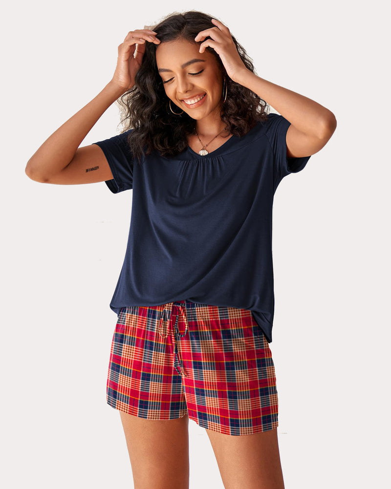 Navy short-sleeve pajama set with gathered neckline and red plaid drawstring shorts