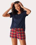 Navy short-sleeve pajama set with gathered neckline and red plaid drawstring shorts