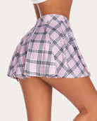 High-waist A-line skirt in pale pink and black plaid, gathered at the waist
