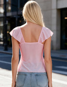 Pale pink sheer mesh top with flutter sleeves and a square back neckline