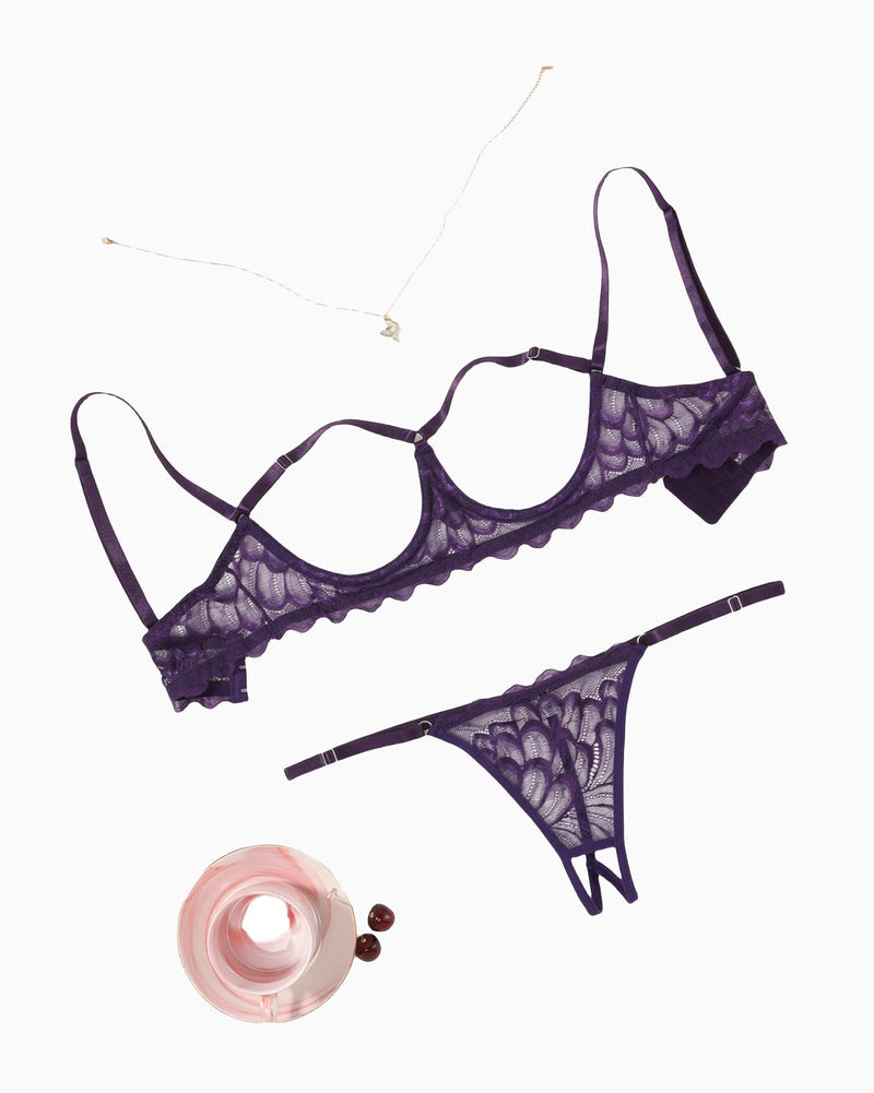 Lace bra and thong-style panty set, scalloped trim, dark purple, flat lay.