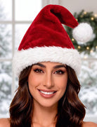 Red Santa hat with white faux fur brim and pom-pom, shown on a model