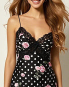 Black lace sleep dress bodice with sweetheart neckline, pink roses, and white polka dot print.