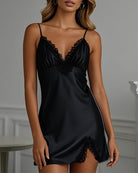 Black mini satin slip dress with thin straps, V-neck lace appliqué, lace hem
