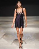Black satin slip dress with floral bra-style trim and scalloped lace hem