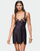 Black slip dress with lace-trim spaghetti straps and pink floral bust detail