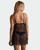Black sheer lace babydoll with open back, lace panels, scalloped hem, thin straps